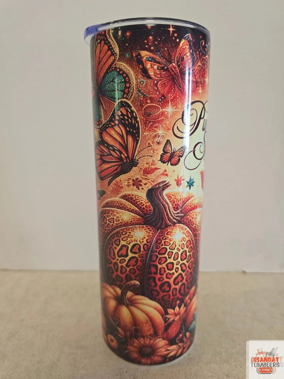 Decorative cylindrical object with butterfly and leopard print design on a plain background