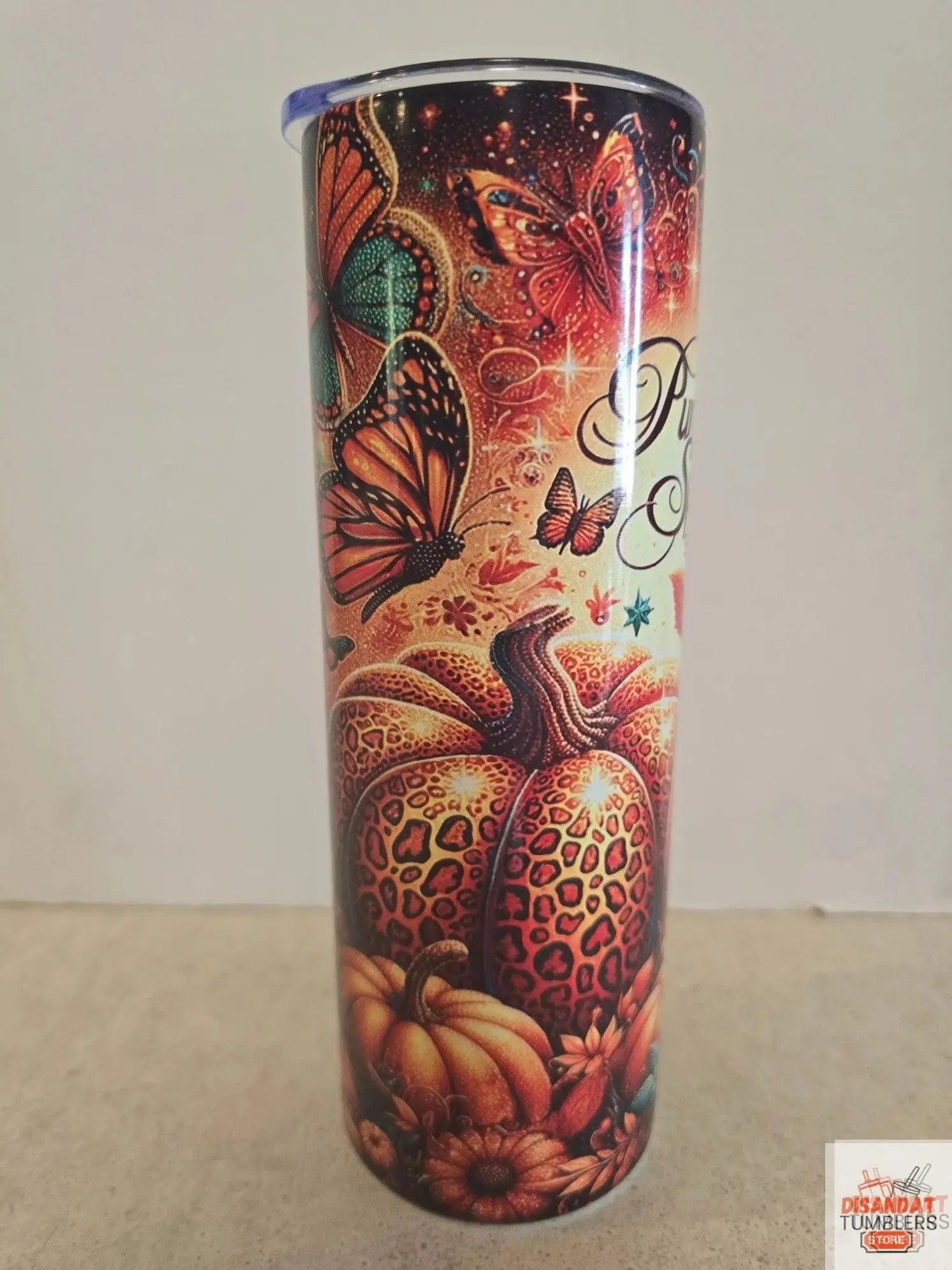 Decorative cylindrical object with butterfly and leopard print design on a plain background