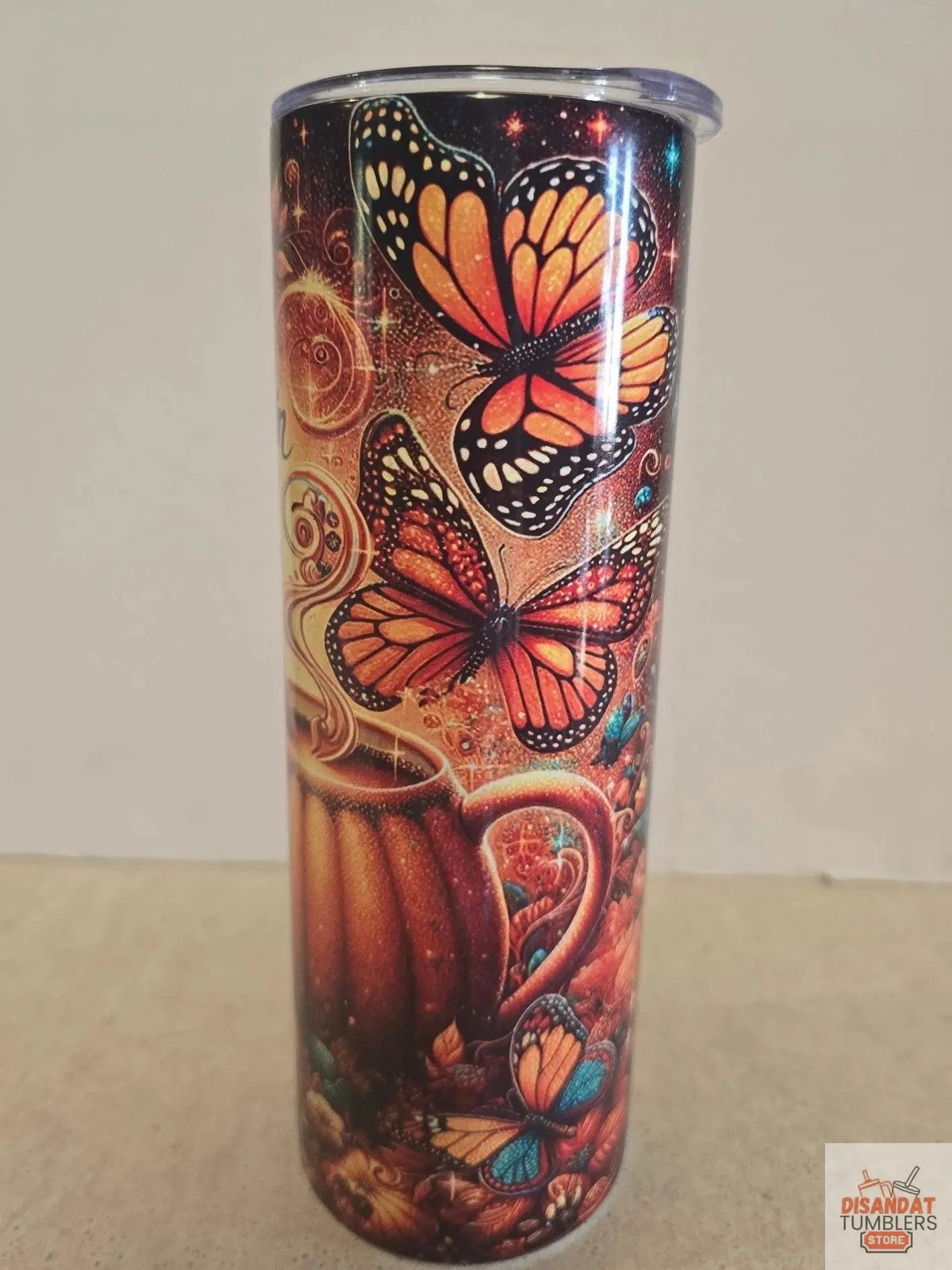 Tumbler with butterfly design on a plain background