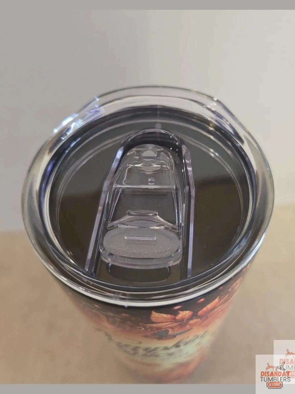 Close-up of a tumbler with a clear lid on a neutral background
